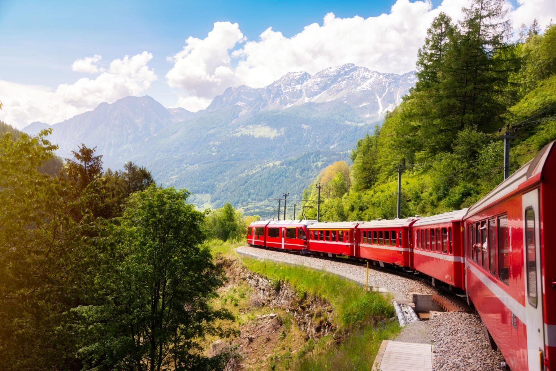 Red Swiss panoramic train through the Alps
