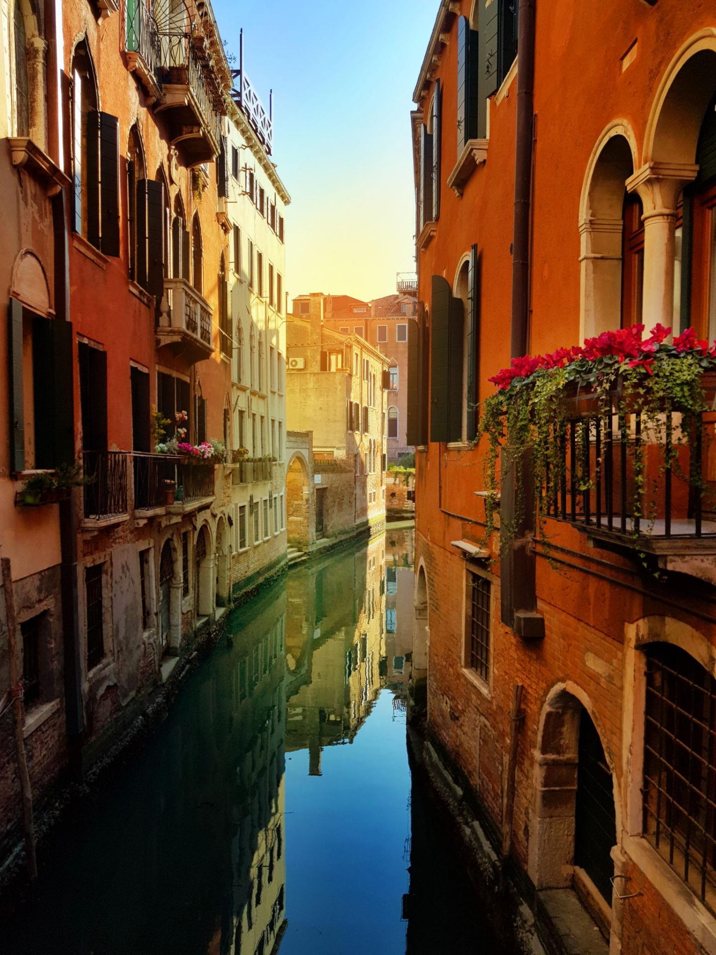 Quiet Venetian side canal with reflections